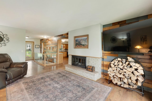 13100 Island View Dr NW, Elk River, MN 55330 - living area featuring wood finished floors and a brick fireplace