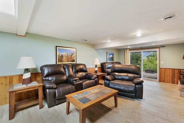13100 Island View Dr NW, Elk River, MN 55330 - living room featuring wainscoting, wood walls, and light wood-style floors