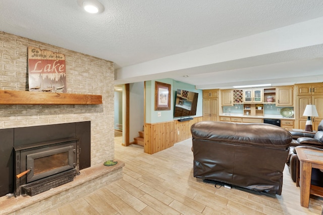 13100 Island View Dr NW, Elk River, MN 55330 - living area with light wood finished floors, a wainscoted wall, a textured ceiling, a brick fireplace, and wooden walls