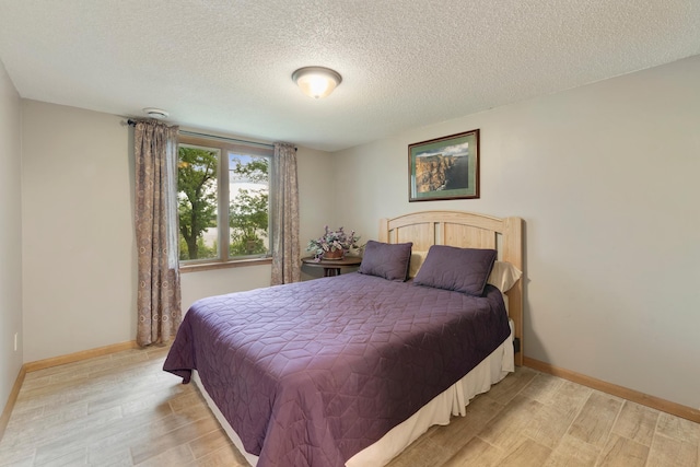 13100 Island View Dr NW, Elk River, MN 55330 - bedroom featuring light wood finished floors, a textured ceiling, and baseboards