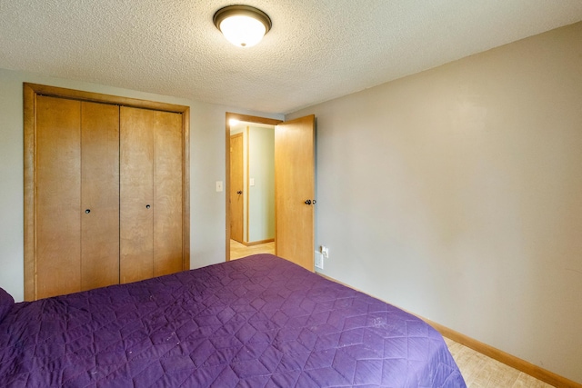 13100 Island View Dr NW, Elk River, MN 55330 - bedroom with a textured ceiling, a closet, and baseboards