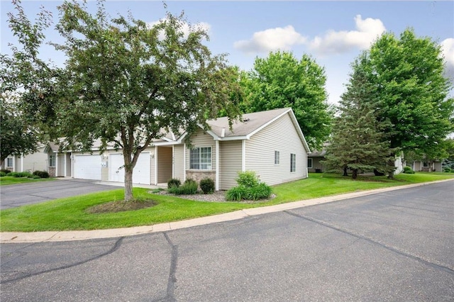 11509 Quay St, Coon Rapids, MN 55433 - view of front of house featuring driveway, a front yard, and a garage