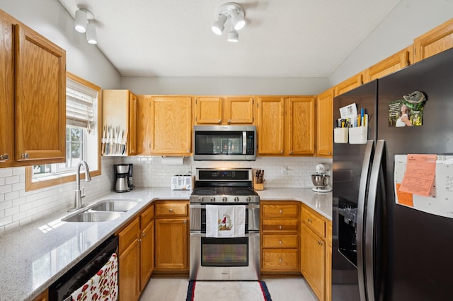 11509 Quay St, Coon Rapids, MN 55433 - kitchen featuring stainless steel appliances, a sink, light stone countertops, and backsplash