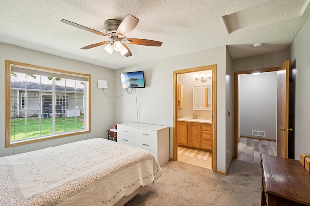 11509 Quay St, Coon Rapids, MN 55433 - bedroom featuring a sink, a textured ceiling, light carpet, ensuite bath, and a ceiling fan