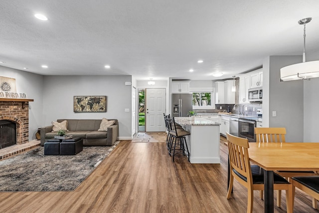 320 Ford Rd Unit 3, Saint Louis Park, MN 55426 - dining room featuring wood finished floors, recessed lighting, and a brick fireplace