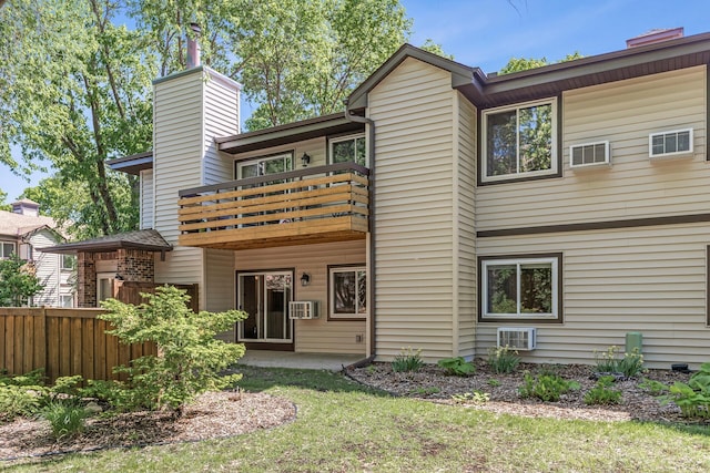 320 Ford Rd Unit 3, Saint Louis Park, MN 55426 - rear view of house featuring a balcony, a chimney, and a wall unit AC