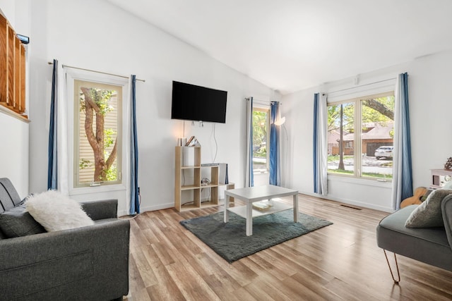 5554 Knoll Dr, Shoreview, MN 55126 - living area featuring lofted ceiling, light wood-style floors, and baseboards