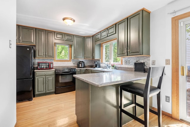 5554 Knoll Dr, Shoreview, MN 55126 - kitchen with freestanding refrigerator, electric stove, a peninsula, a sink, and decorative backsplash