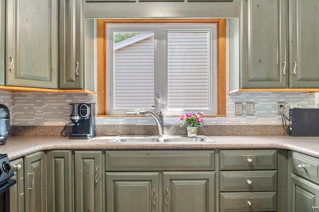 5554 Knoll Dr, Shoreview, MN 55126 - kitchen with green cabinetry, a sink, backsplash, and light countertops