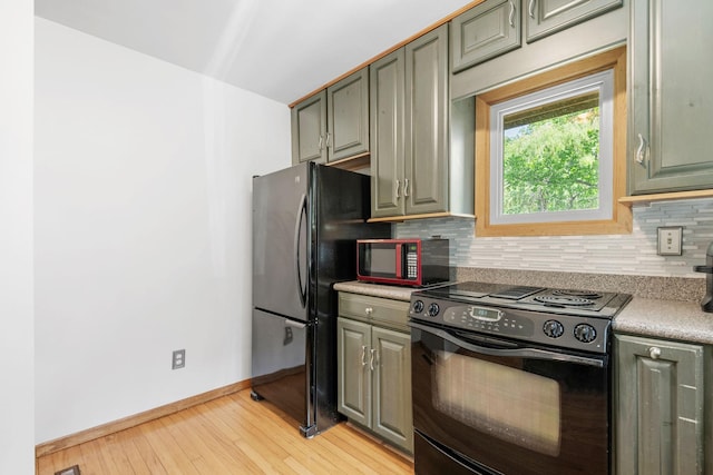 5554 Knoll Dr, Shoreview, MN 55126 - kitchen featuring black appliances, baseboards, decorative backsplash, light wood-style flooring, and light countertops