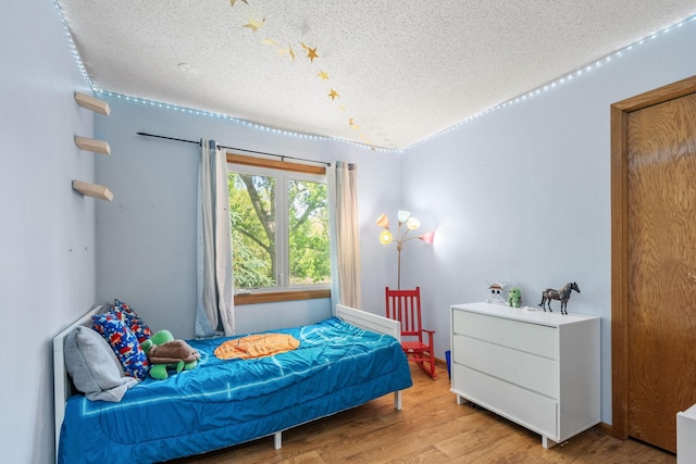5554 Knoll Dr, Shoreview, MN 55126 - bedroom with a textured ceiling and wood finished floors