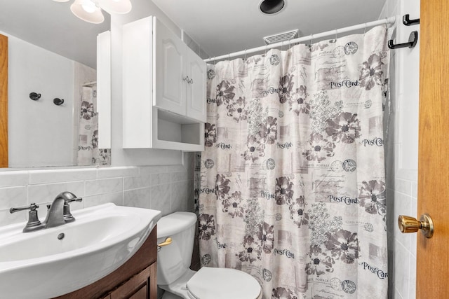 5554 Knoll Dr, Shoreview, MN 55126 - bathroom with vanity, toilet, tile walls, and a shower with curtain