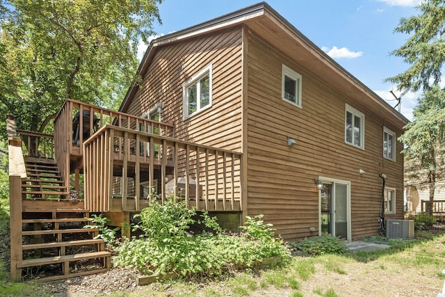 5554 Knoll Dr, Shoreview, MN 55126 - back of property with stairs, central AC unit, and a deck