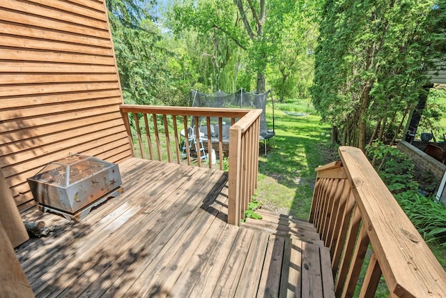 5554 Knoll Dr, Shoreview, MN 55126 - wooden deck featuring a trampoline and a lawn