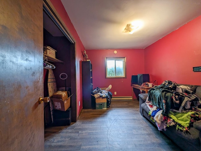 1422 6th St SE, Wadena, MN 56482 - bedroom with a baseboard radiator, wood finished floors, and baseboards