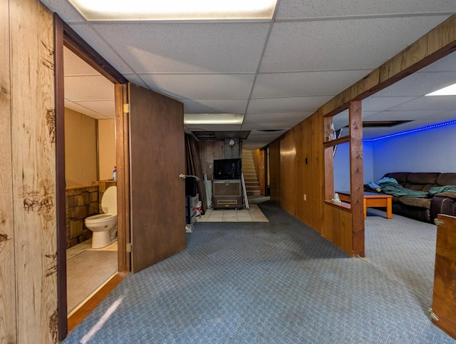 1422 6th St SE, Wadena, MN 56482 - hallway with a drop ceiling, carpet, and wooden walls