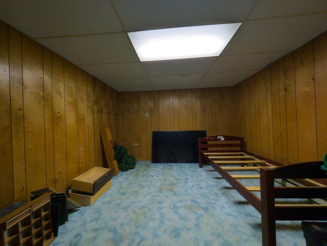 1422 6th St SE, Wadena, MN 56482 - bedroom featuring a paneled ceiling, wood walls, and carpet flooring