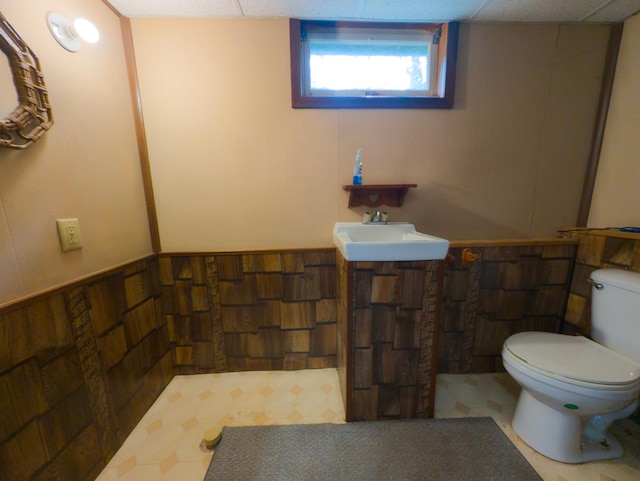 1422 6th St SE, Wadena, MN 56482 - half bathroom featuring toilet, a sink, and tile patterned floors