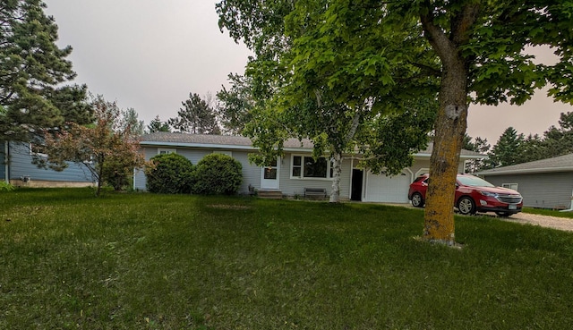 1422 6th St SE, Wadena, MN 56482 - view of front facade featuring an attached garage, entry steps, a front lawn, and driveway