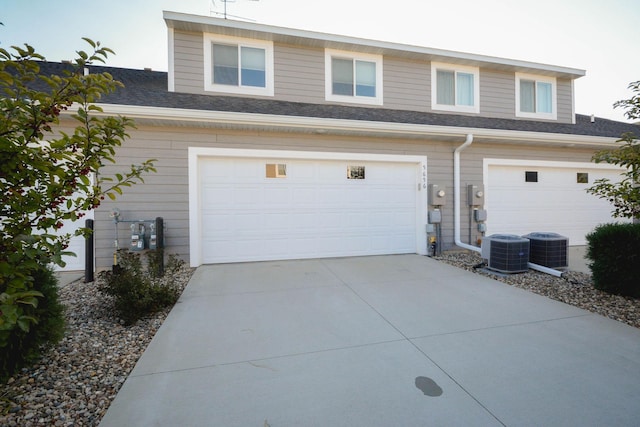 5656 Harvest Moon Blvd NW, Rochester, MN 55901 - garage with cooling unit and concrete driveway