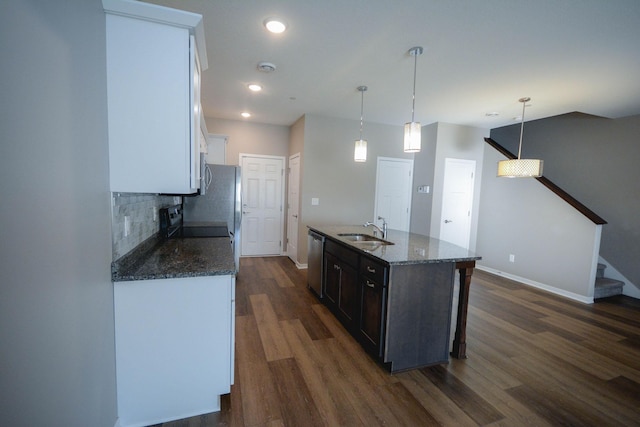 5656 Harvest Moon Blvd NW, Rochester, MN 55901 - kitchen with a sink, dishwasher, dark wood-style flooring, baseboards, and dark stone counters