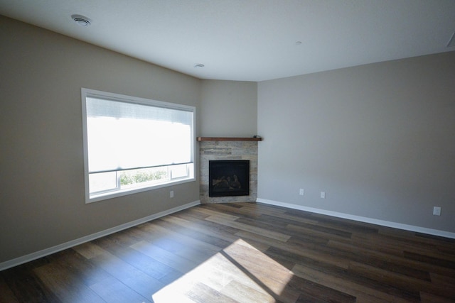 5656 Harvest Moon Blvd NW, Rochester, MN 55901 - unfurnished living room featuring dark wood finished floors, a stone fireplace, and baseboards