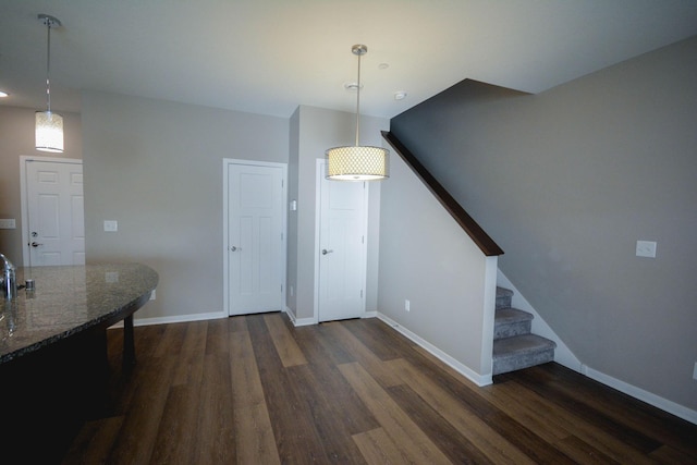 5656 Harvest Moon Blvd NW, Rochester, MN 55901 - dining area with dark wood-type flooring, stairs, and baseboards
