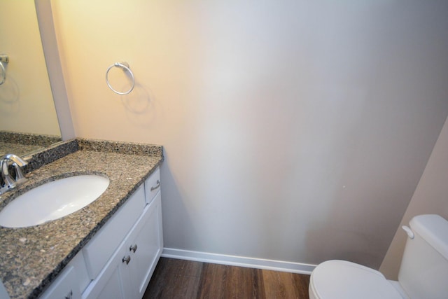 5656 Harvest Moon Blvd NW, Rochester, MN 55901 - half bathroom featuring toilet, wood finished floors, baseboards, and vanity