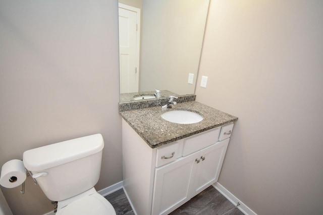 5656 Harvest Moon Blvd NW, Rochester, MN 55901 - half bathroom with toilet, vanity, baseboards, and wood finished floors