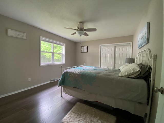 3771 County Line Rd, Moose Lake Twp, MN 55783 - bedroom featuring baseboards, a closet, dark wood finished floors, and ceiling fan