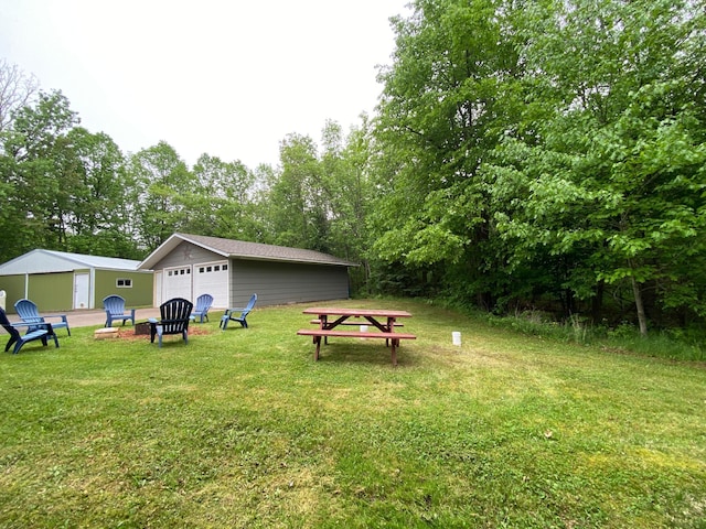 3771 County Line Rd, Moose Lake Twp, MN 55783 - view of grassy yard featuring a garage, an outdoor structure, and view of scattered trees