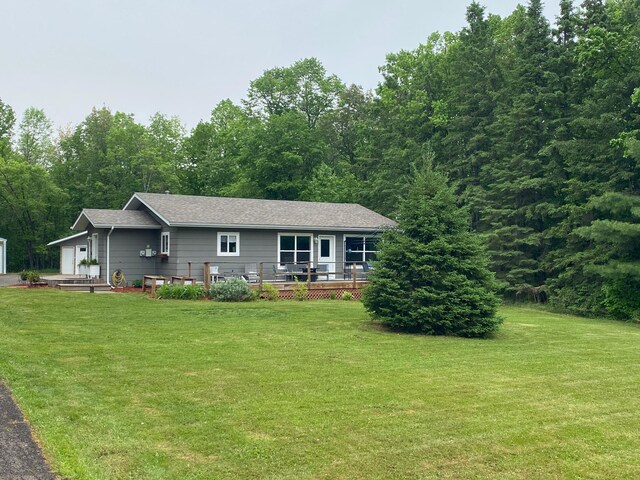 3771 County Line Rd, Moose Lake Twp, MN 55783 - view of front of house with a front yard, a wooden deck, and roof with shingles