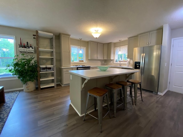 3771 County Line Rd, Moose Lake Twp, MN 55783 - kitchen with stainless steel fridge, dark wood-type flooring, light countertops, a center island, and a sink