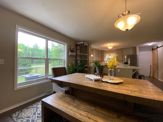 3771 County Line Rd, Moose Lake Twp, MN 55783 - dining space with a barn door, baseboards, and dark wood-style floors