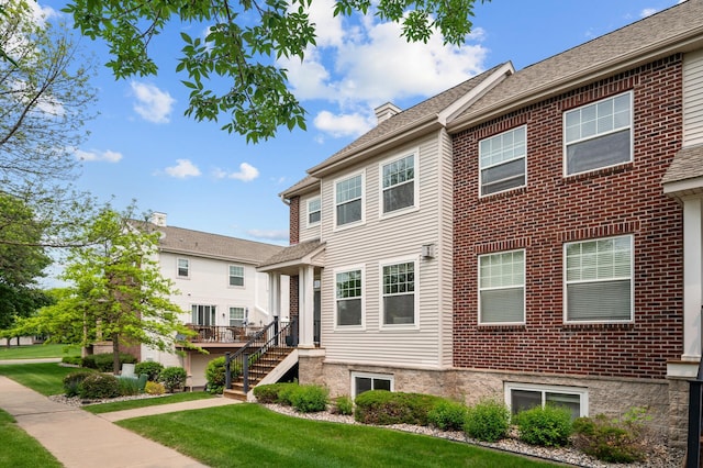 2099 Clover Ridge Dr, Chaska, MN 55318 - view of front facade featuring a front yard, stairs, and a chimney