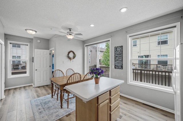 2099 Clover Ridge Dr, Chaska, MN 55318 - dining area featuring baseboards, light wood-style floors, a textured ceiling, a ceiling fan, and recessed lighting