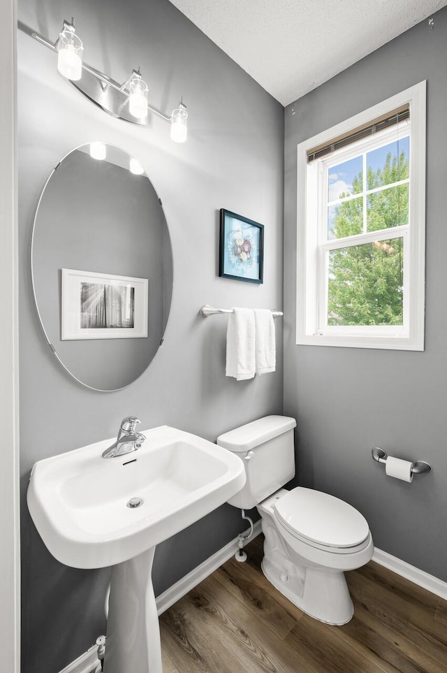 2099 Clover Ridge Dr, Chaska, MN 55318 - bathroom with baseboards, toilet, and wood finished floors