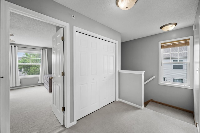 2099 Clover Ridge Dr, Chaska, MN 55318 - unfurnished bedroom featuring a textured ceiling, carpet floors, baseboards, and a closet