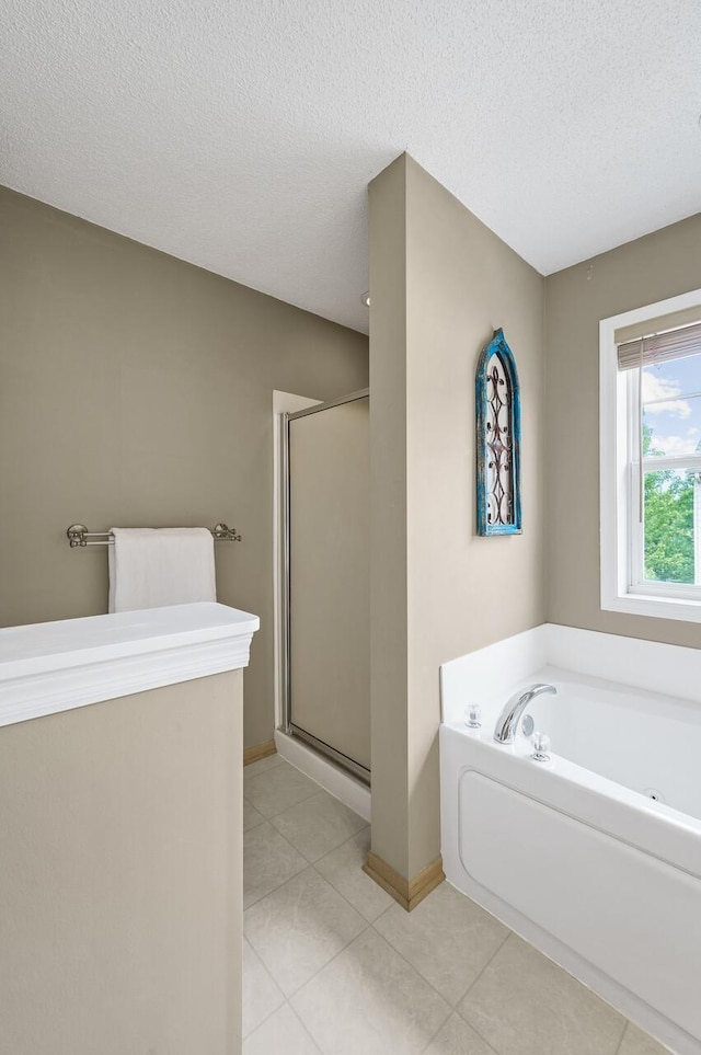 2099 Clover Ridge Dr, Chaska, MN 55318 - bathroom with a shower stall, a garden tub, tile patterned floors, a textured ceiling, and baseboards