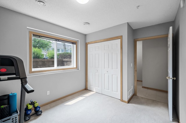 2099 Clover Ridge Dr, Chaska, MN 55318 - unfurnished bedroom featuring a textured ceiling, carpet floors, a closet, and baseboards