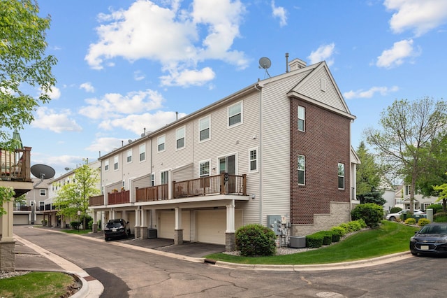 2099 Clover Ridge Dr, Chaska, MN 55318 - view of building exterior with central AC unit, an attached garage, and a residential view