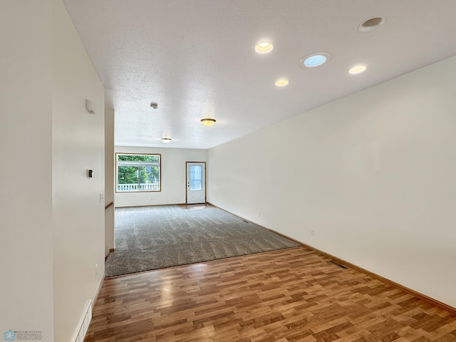 816 3rd St N Unit 816, Fargo, ND 58102 - unfurnished room featuring baseboards, wood finished floors, recessed lighting, and a textured ceiling