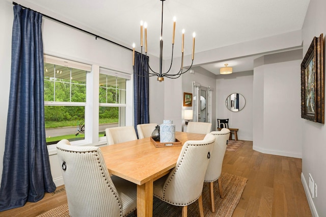 6100 151st St, Savage, MN 55378 - dining space featuring a chandelier, baseboards, and wood finished floors