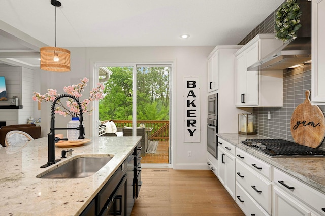 6100 151st St, Savage, MN 55378 - kitchen with exhaust hood, appliances with stainless steel finishes, a sink, light wood finished floors, and white cabinetry
