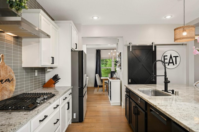 6100 151st St, Savage, MN 55378 - kitchen with stainless steel appliances, wall chimney exhaust hood, a sink, white cabinetry, and tasteful backsplash