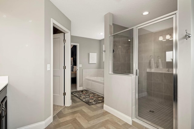6100 151st St, Savage, MN 55378 - bathroom featuring a garden tub, a stall shower, baseboards, vanity, and recessed lighting