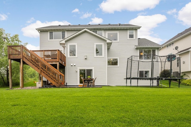 6100 151st St, Savage, MN 55378 - back of house featuring a trampoline, a wooden deck, a yard, and stairs