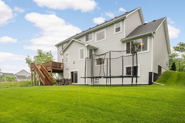 6100 151st St, Savage, MN 55378 - back of house with a deck, stairway, a trampoline, and a yard