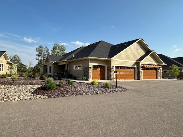 7496 Fairway Ln, Breezy Point, MN 56472 - craftsman-style home with stone siding, a garage, and driveway