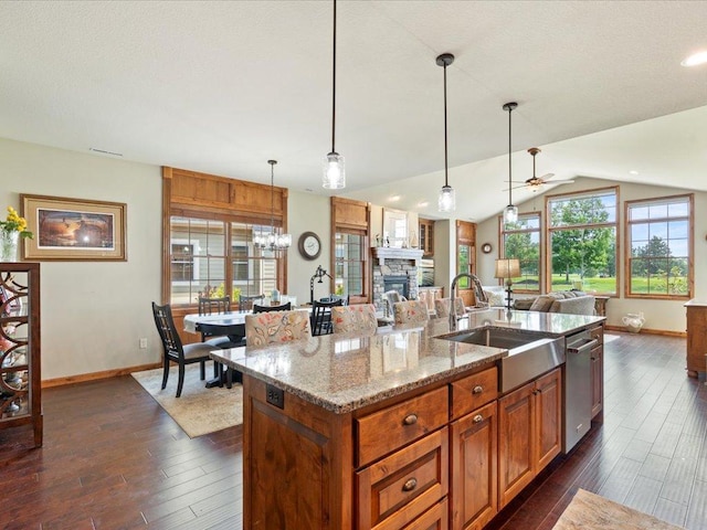 7496 Fairway Ln, Breezy Point, MN 56472 - kitchen featuring open floor plan, a ceiling fan, a stone fireplace, dark wood-type flooring, and lofted ceiling